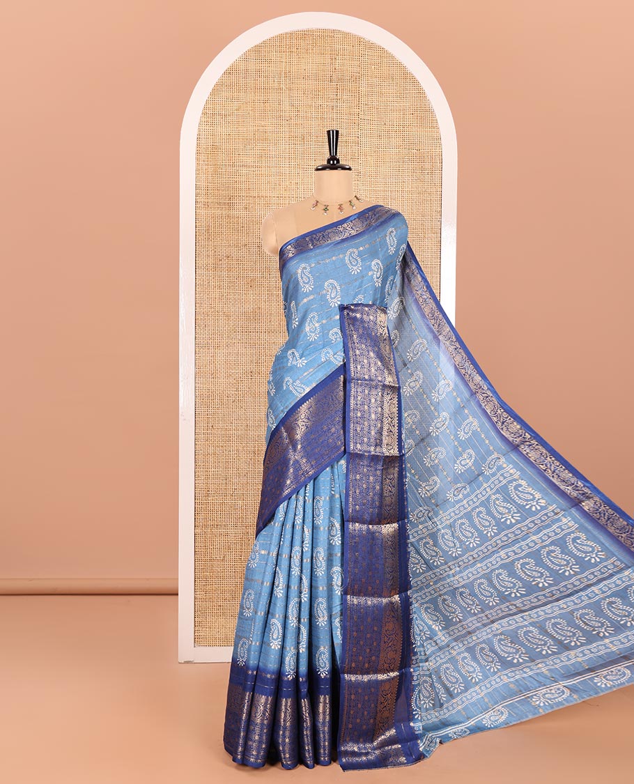 Blue Dola Silk Saree Adorned with Paisley Buttas, and Horizontal Zari Stripes All Over Its Body, Complemented by Contrast Floral Creeper Zari Design Border, Pallu Steeped with Paisleys, and Paired with a Contrast Blouse
