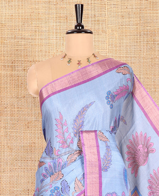 Blue Manipuri Silk Saree Embellished with Kalamkari Floral and Peacock Prints All Over Its Body, Complemented by a Contrast Zari Border, Pallu Depicts a Big Peacock and Paisleys, and Paired with a Contrast Printed Blouse