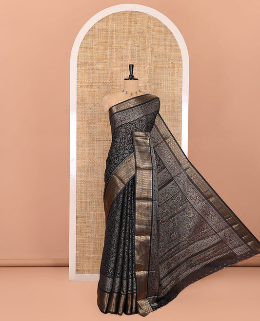 Black Dola Silk Saree, Subtly Designed with Floral Jaal Print All Over Its Body, Highlighted by Traditional Zari Designs Woven Border, Pallu Replicates the Same Body Print, and Comes with a Matching Blouse