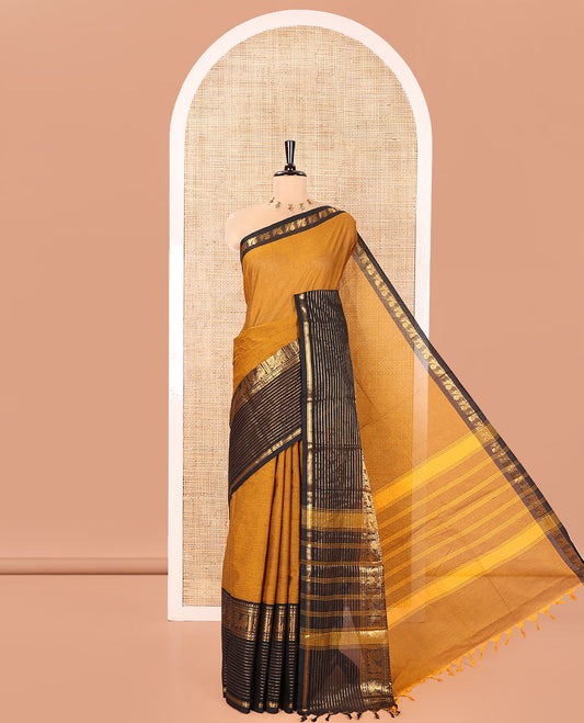 Mustard Plain Chettinad Cotton Saree, Complemented by a Contrast Zari Traditional Border Steeped with  Peacock Designs, Subtly Striped Pallu, and Paired with a Matching Blouse