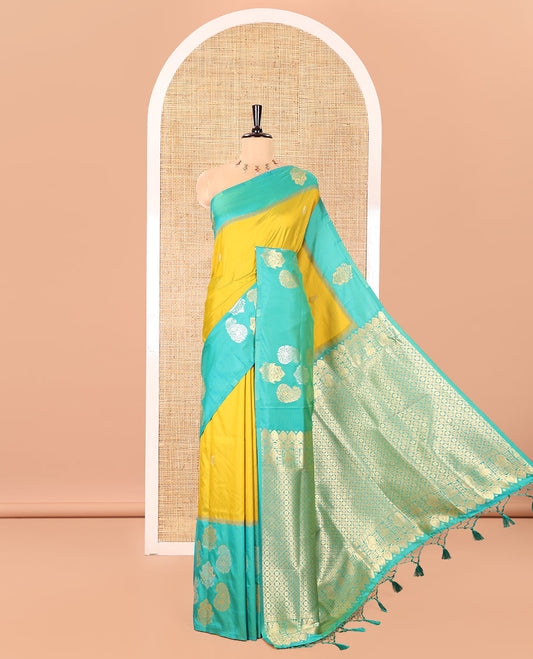 Yellow Elite Soft Silk Saree, Decorated with Zari Buttas All Over Its Body, Complemented by Contrast Border Steeped with Zari Buttas, Grand Jaal Design Pallu, and Paired with a Contrast Blouse