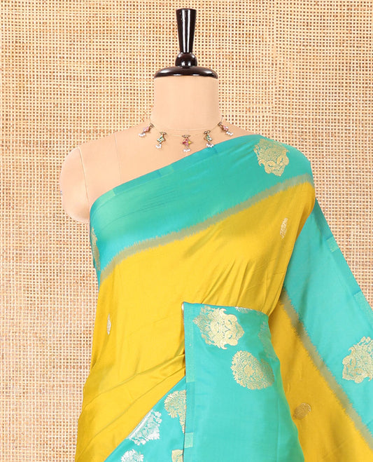 Yellow Elite Soft Silk Saree, Decorated with Zari Buttas All Over Its Body, Complemented by Contrast Border Steeped with Zari Buttas, Grand Jaal Design Pallu, and Paired with a Contrast Blouse