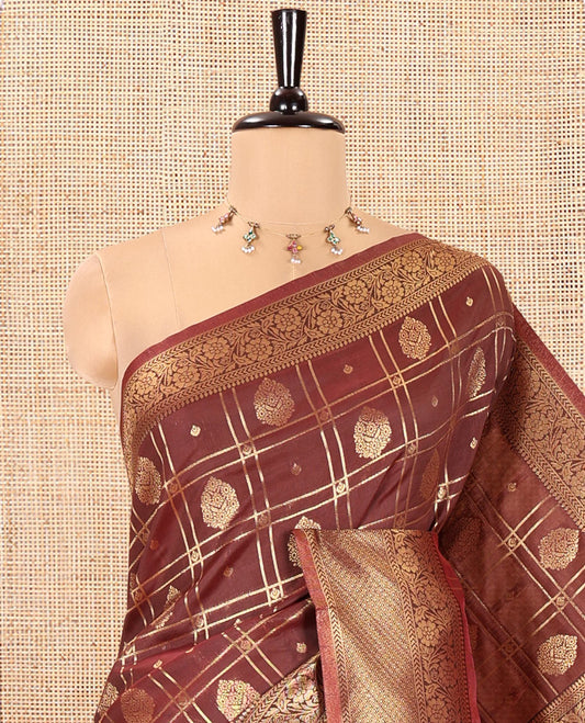 Brown Kanchi Silk Saree, Accentuated with Zari Butta Enclosed Checks All Over Its Body, Highlighted by Traditional Zari Border of Floral Creeper Designs, a Grand Jaal Pallu, and Paired with a Jacquard Blouse