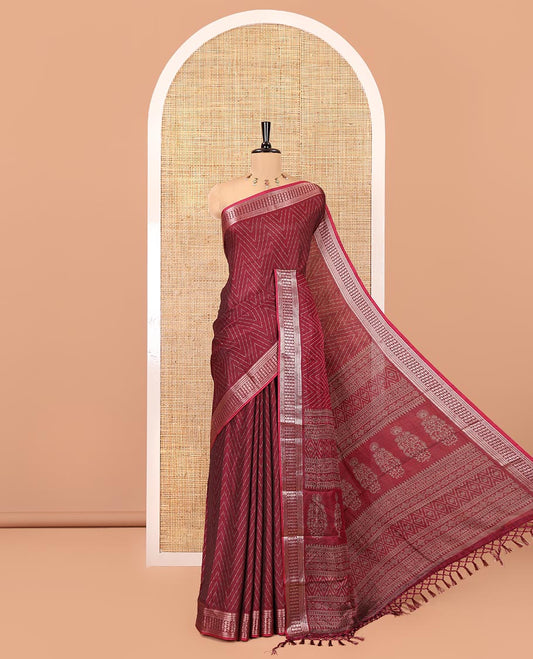 Maroon Dola Silk Saree, Subtly Sparkled with Chevron Stripes on Its Body, Highlighted by Traditional Zari Design Border, Intricately Designed Pallu, and Paired with a Matching Blouse