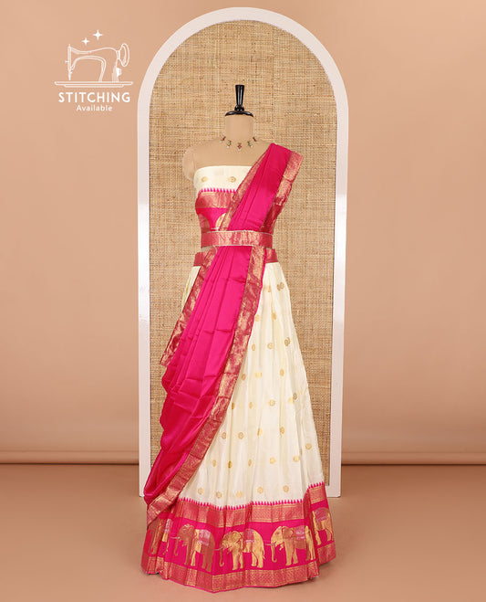 Cream-pink half-saree, zari buttas with contrast traditional zari elephant motifs bordered skirt, matching blouse and a contrast zari border dhavani