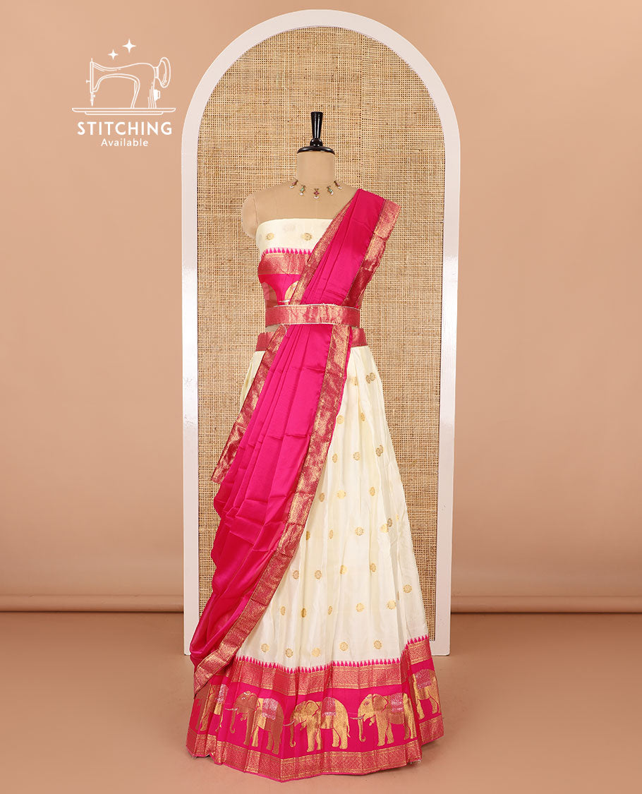 Cream-pink half-saree, zari buttas with contrast traditional zari elephant motifs bordered skirt, matching blouse and a contrast zari border dhavani