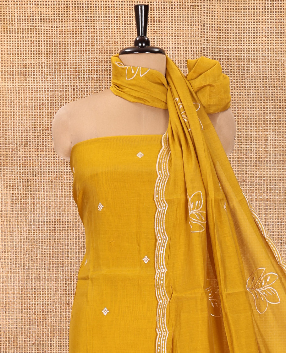 Mustard Mul Chanderi Designer Material Chudidar Set, Meticulously Woven with Big Floral Motifs Embroidered On Its Top, A Plain Santoon Bottom, and Paired with a Mul Chanderi Scallop Thread Embroidered Dupatta