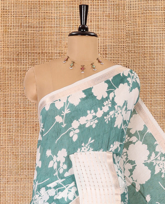Blue silhouette-style floral discharge printed Assam silk saree, contrast traditional zari border of rudraksham motifs, zari striped pallu, and a floral printed blouse