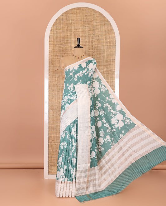 Blue silhouette-style floral discharge printed Assam silk saree, contrast traditional zari border of rudraksham motifs, zari striped pallu, and a floral printed blouse