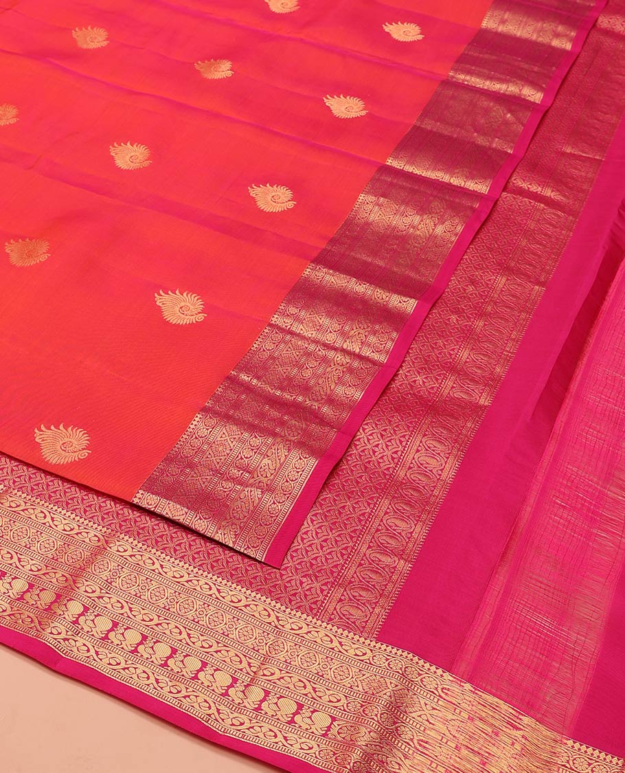 Orange Dual-Tone Vasundhara Lite-Silk Mix Saree, Adorned with Zari Buttas, Complemented by Contrast Border Featuring Thilakam Mokku, Kodi Visiry, Muthu, Laddu Kamalam, and Mayil Designs, Grandly Pallu of Scallop Designs, and Paired with a Contrast Blouse