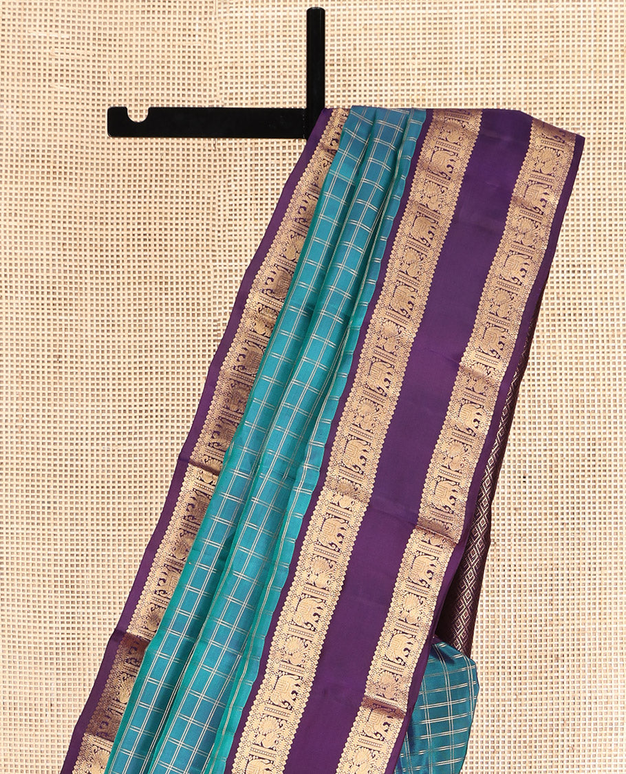 Blue Vasundhara Lite Silk Mix Saree, Spotlighted with Checks, Complemented by a Contrast Rettai Pettu Border of Thilakam Mokku, Yaanai and Mayil Design, Jaal Pallu, and a Contrast Blouse