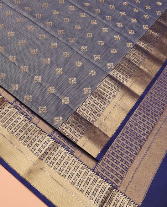 Grey Vasundhara Lite Silk Mix Saree Majestically Detailed with Floral Buttas Across Its Body, Contrast Border of Ara Bogudi, Banaras, and Kamalam Designs, Pallu Decked Up with Zari, and Has a Contrast Blouse