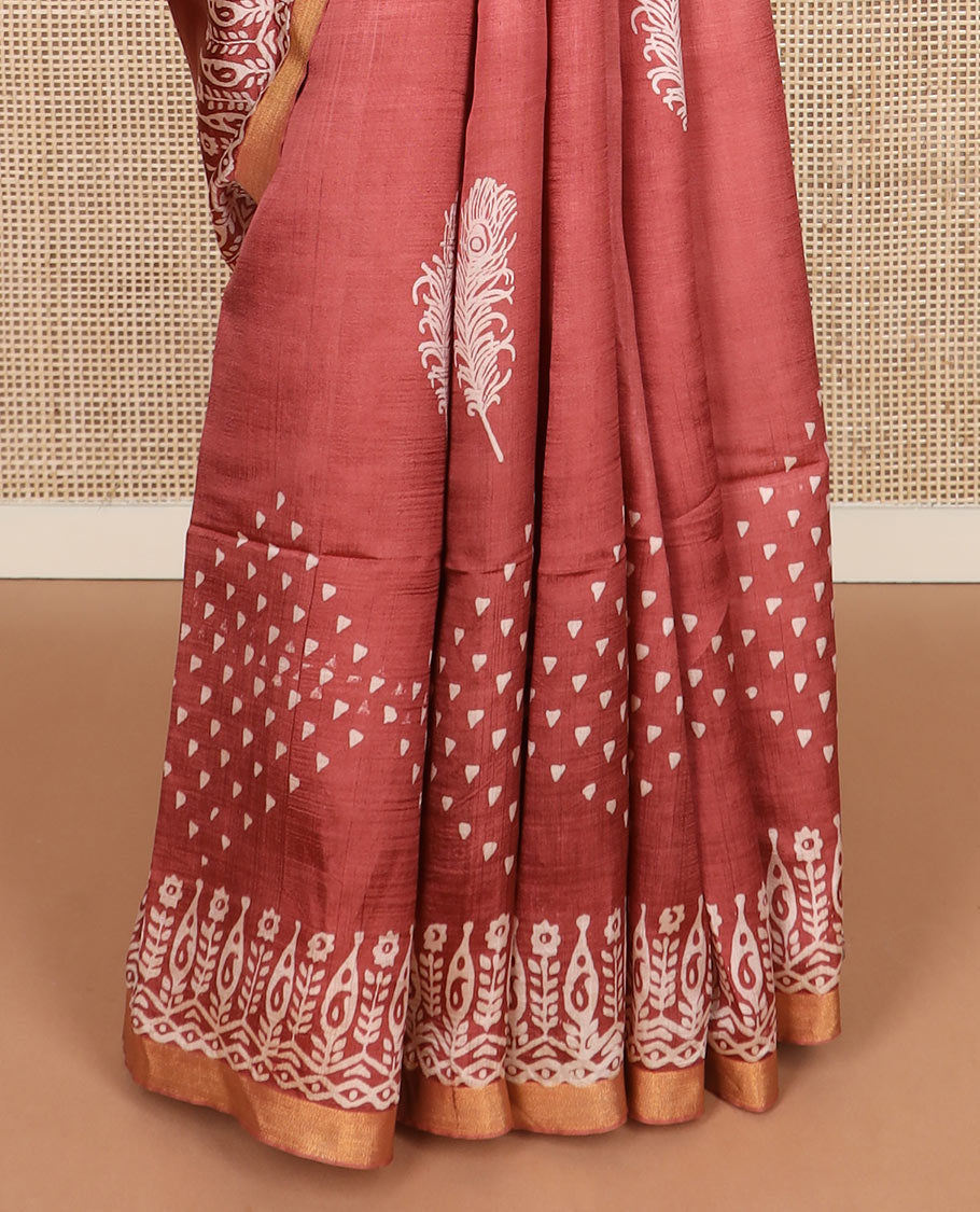 Terracotta red feather motifs printed banana pith saree, zari with print work border, and printed pallu