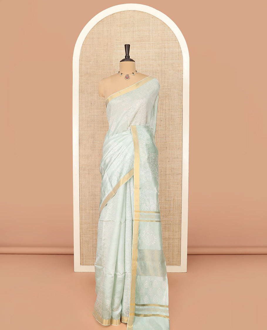 Pastel Green Banana Pith Saree Sparsely Sparkled with Intricate Motifs Printed All Over Its Body, Zari Bavanji Border, Pallu of Print and Zari Work, and Paired with a Matching Blouse
