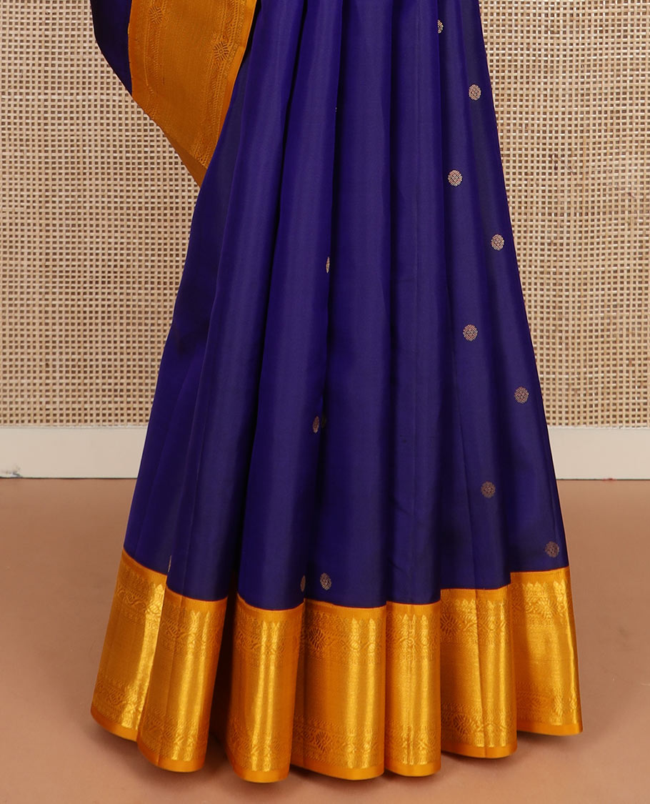 Blue zari buttas silk saree, contrast border of thilakam mokku, manga and floral designs, and jaal pallu