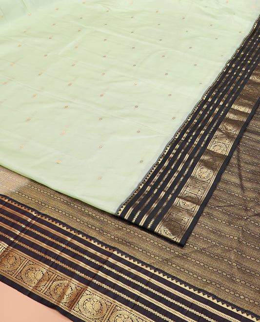 Green Vasundhara Silk Saree Accentuated with Kamalam Buttas, Complemented by a Contrast Varisai Pettu Border of Rekku, Muthu, Neli, and Round Mayil Designs, Grandly Pallu Steeped Geometric Designs, and a Contrast Blouse