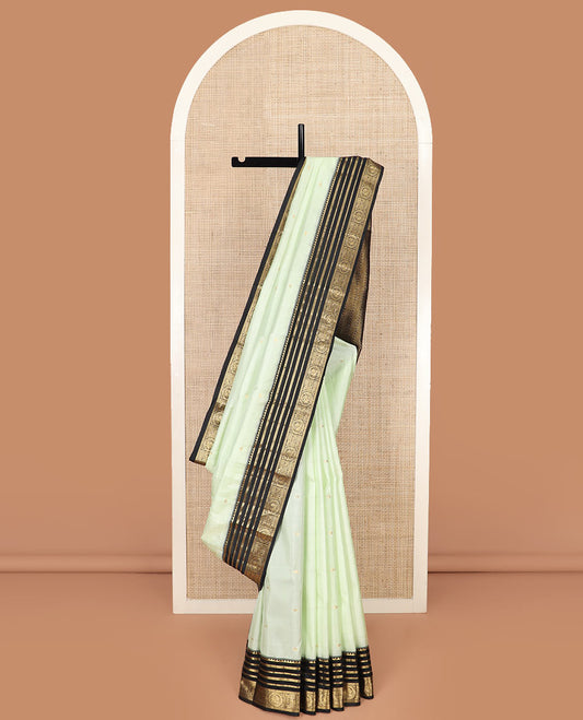 Green Vasundhara Silk Saree Accentuated with Kamalam Buttas, Complemented by a Contrast Varisai Pettu Border of Rekku, Muthu, Neli, and Round Mayil Designs, Grandly Pallu Steeped Geometric Designs, and a Contrast Blouse