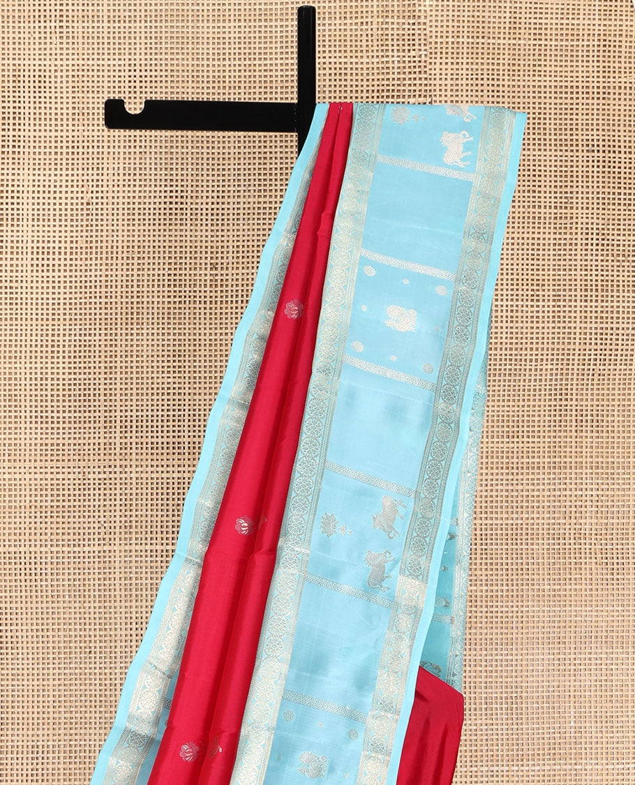 Red Vasundhara Silk Saree, Embellished with Floral Buttas on Its Body, Complemented by Contrast Border of Kodi Visiry, Annam, Pichwai Cow and Lotus Designs, Meticulously Crafted Pallu, and Paired with a Contrast Blouse