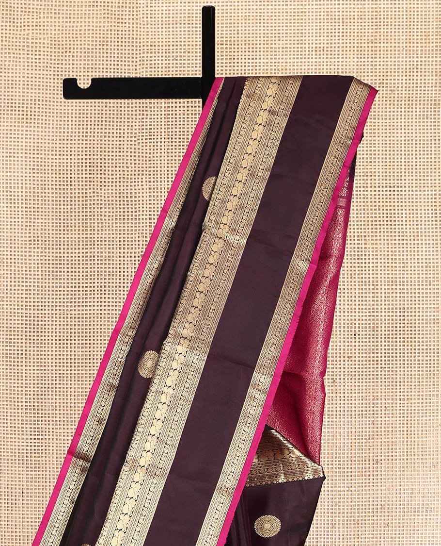 Maroon Vasundhara Silk Saree, Spotlighted with Chakram Buttas, a Rettai Pettu Border of Muthu, Kodi Visiry, and Mayil Designs, Contrast Grand Pallu, and a Contrast Blouse