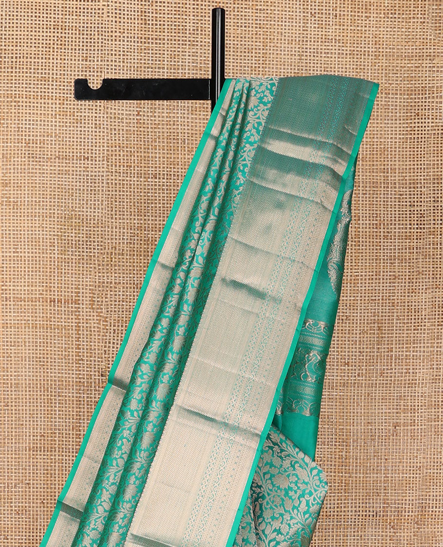 Turquoise jacquard Kanchipuram wedding silk saree, zari border of kathir, mayil kann, rettai neli, and lavangam kodi designs, and manga design pallu