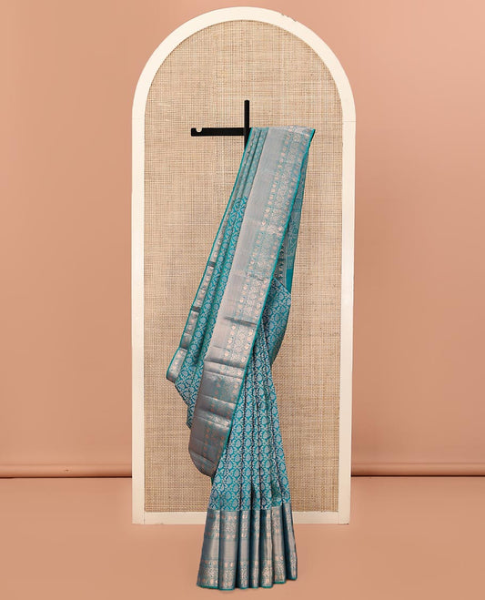 Rama Blue Kanchipuram Wedding Silk Saree, Mesmerized with Jaal Jacquard on Its Body, Highlighted by a Zari Border of Thilakam Mokku, Poun, Mayil, and Kodi Visiry Designs, Grand Pallu Steeped with Chakram Designs, and Paired with a Matching Blouse