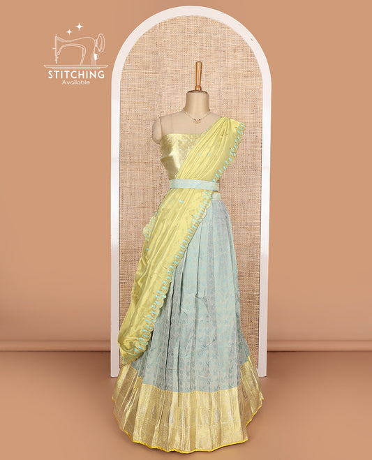 Pastel green art silk half-saree, brocade with contrast traditional border skirt, contrast brocade blouse, scallop embroidered dhavani, and detachable belt