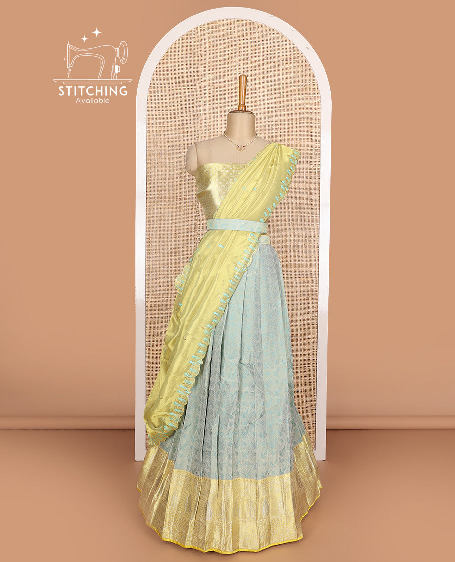Pastel green art silk half-saree, brocade with contrast traditional border skirt, contrast brocade blouse, scallop embroidered dhavani, and detachable belt