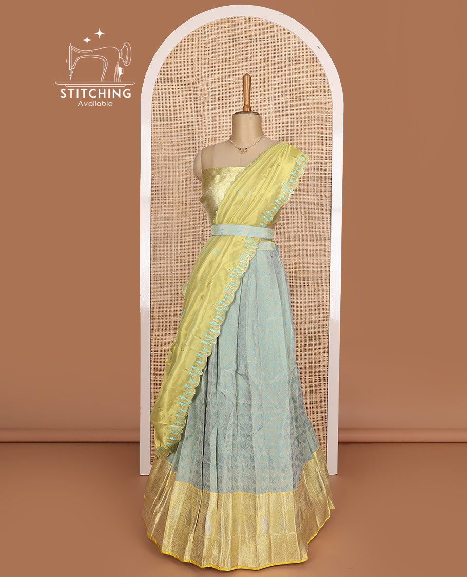 Pastel green art silk half-saree, brocade with contrast traditional border skirt, contrast brocade blouse, scallop embroidered dhavani, and detachable belt
