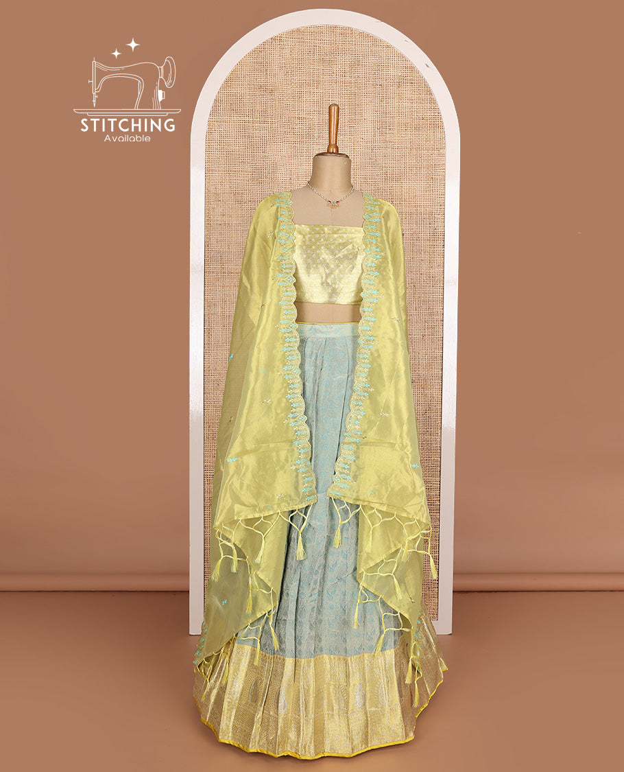 Pastel green art silk half-saree, brocade with contrast traditional border skirt, contrast brocade blouse, scallop embroidered dhavani, and detachable belt