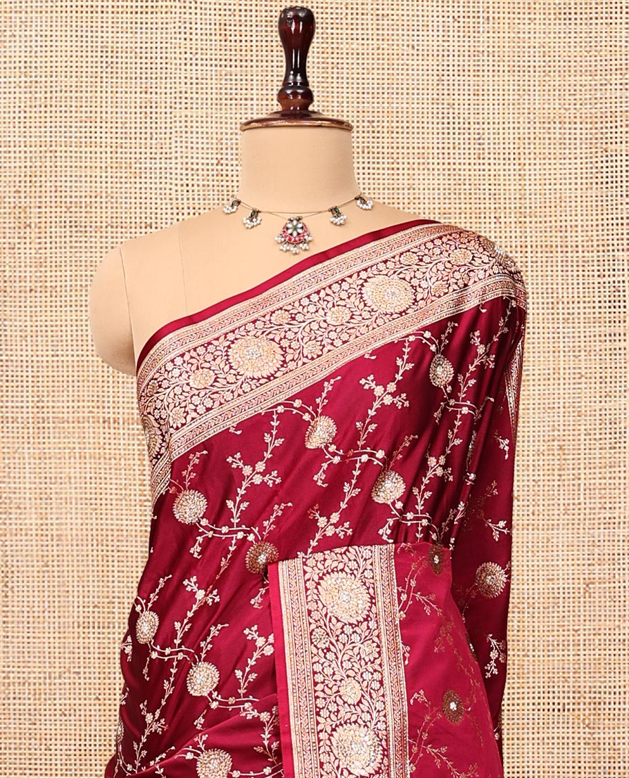 Red Wine Banarasi Satin Saree, Gleamed Up with Floral Jaal Jacquard, a Floral Creeper Border, Intricate Stonework Pallu, and a Matching Blouse