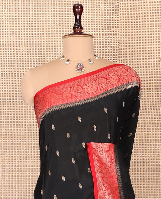 Black Fancy Crepe Saree, Spotlighted with Buttas, Complemented by a Contrast Floral Creeper Border, Intricately Designed Pallu, and a Contrast Blouse