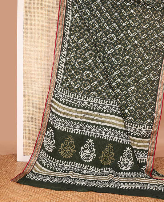 Green batik circle motifs printed mul mul cotton saree, contrast traditional thread border, and batik printed pallu