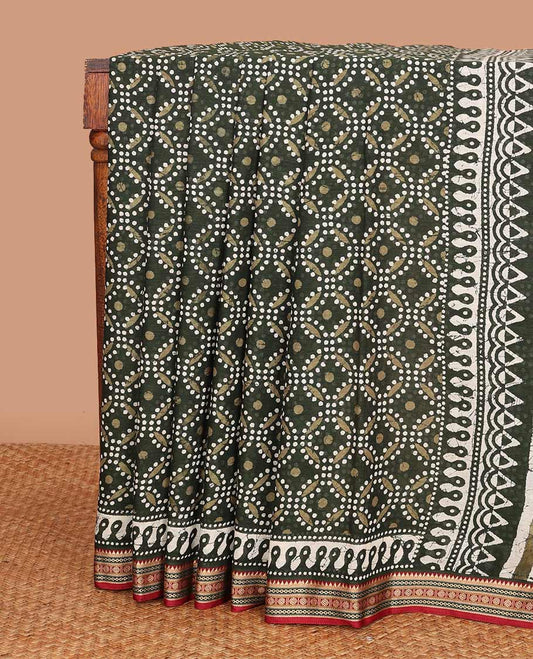Green batik circle motifs printed mul mul cotton saree, contrast traditional thread border, and batik printed pallu