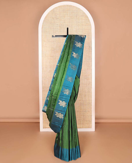 Dark green buttas kancheepuram silk saree with contrast floral design border & striped, floral motifs pallu