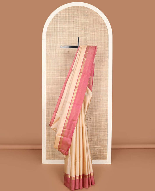 Cream buttas Kanchipuram silk saree, contrast kaal erangina border of thilakam mokku, muthu, and kathir designs and pallu of thilakam mokku, and kathir designs