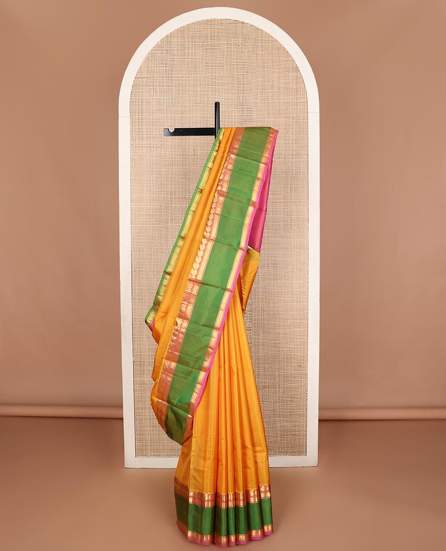 Yellow striped Kanchipuram silk saree, contrast ganga jamuna rettai pettu border of manga, banaras, and mayil kann designs, and zari striped pallu