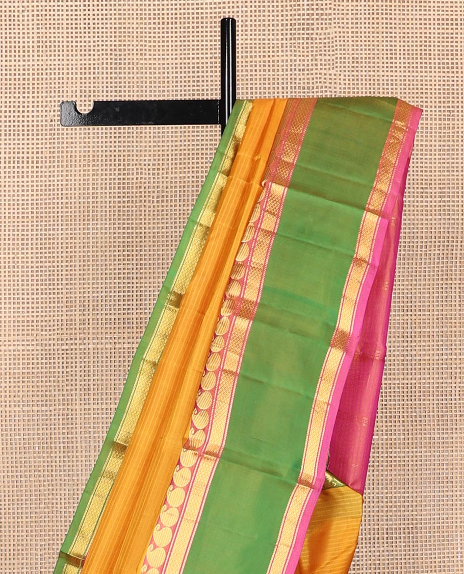 Yellow striped Kanchipuram silk saree, contrast ganga jamuna rettai pettu border of manga, banaras, and mayil kann designs, and zari striped pallu