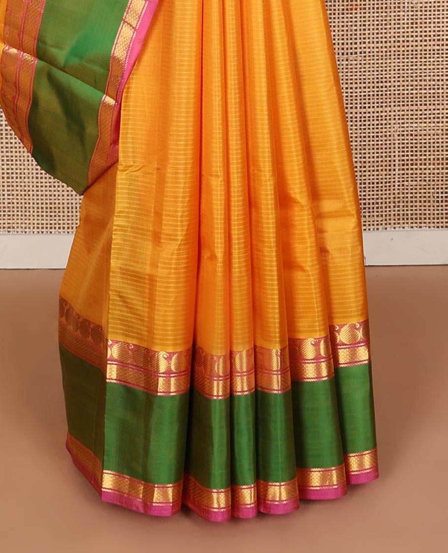 Yellow striped Kanchipuram silk saree, contrast ganga jamuna rettai pettu border of manga, banaras, and mayil kann designs, and zari striped pallu