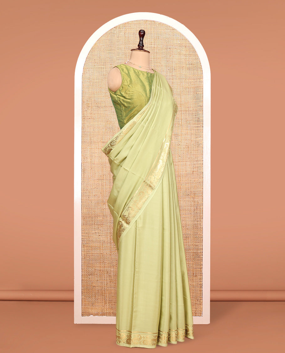 Green Plain Mysore Silk Saree, Highlighted by a Traditional Zari Border of Peacock Designs, Pallu Steeped with Zari Stripes, and Paired with a Matching Blouse