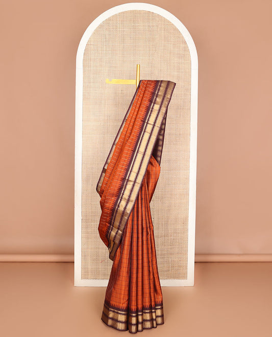Orange checked Vasundhara soft silk saree, contrast temple border of manga mokku, muthu & mayil kann & zari design pallu