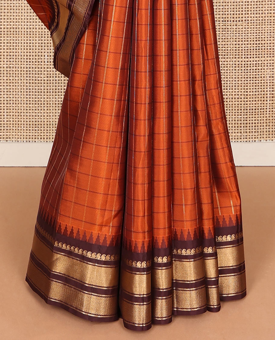 Orange checked Vasundhara soft silk saree, contrast temple border of manga mokku, muthu & mayil kann & zari design pallu