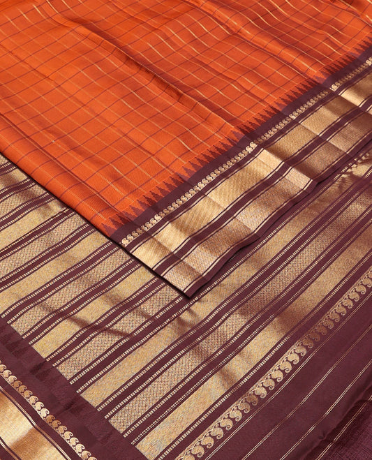 Orange checked Vasundhara soft silk saree, contrast temple border of manga mokku, muthu & mayil kann & zari design pallu