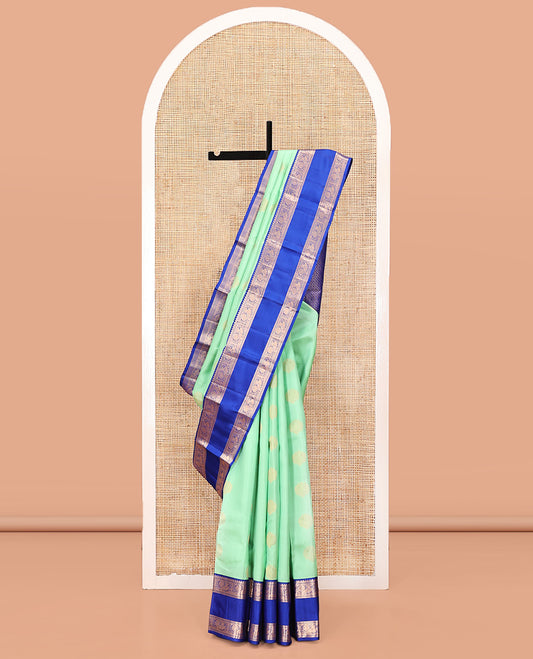 Pastel Sea Green Vasundhara Silk Saree, Ornamented with Zari Buttas All Over Its Body, Complemented by a Contrast Rettai Pettu Border of Rekku, Ara Maadam, and Mayil Designs, Grand Pallu, and Paired with a Contrast Blouse