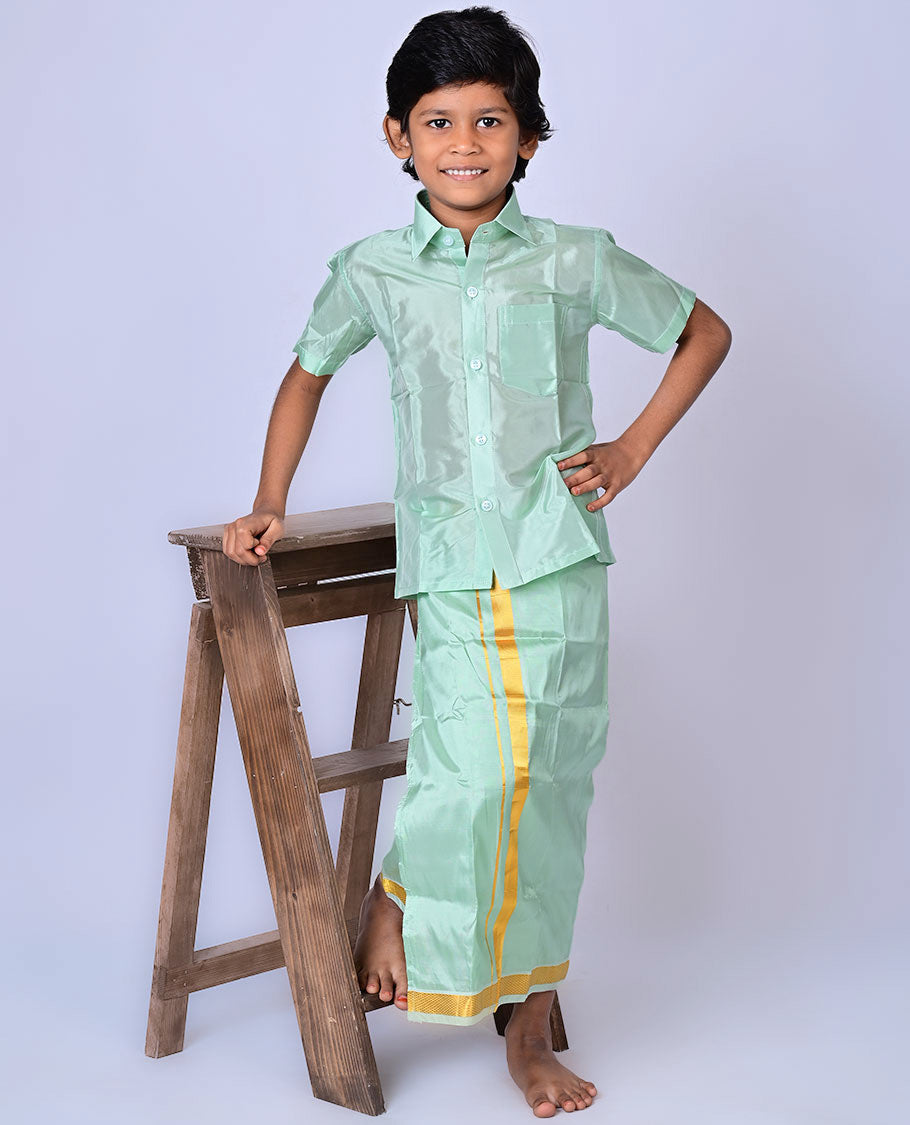 Pista green art-silk boys dhoti set features a solid half-sleeve shirt & zari border velcro dhoti 