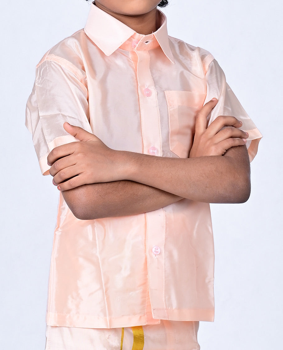 Coral art-silk boys dhoti set features a solid half-sleeve shirt & zari border velcro dhoti 