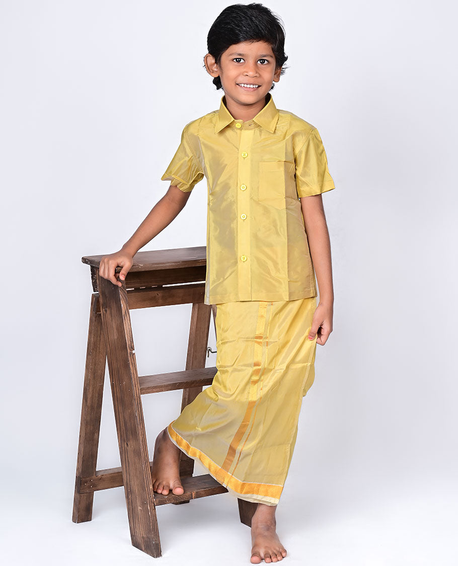 Biscuit color art-silk boys dhoti set features a solid half-sleeve shirt & zari border velcro dhoti 