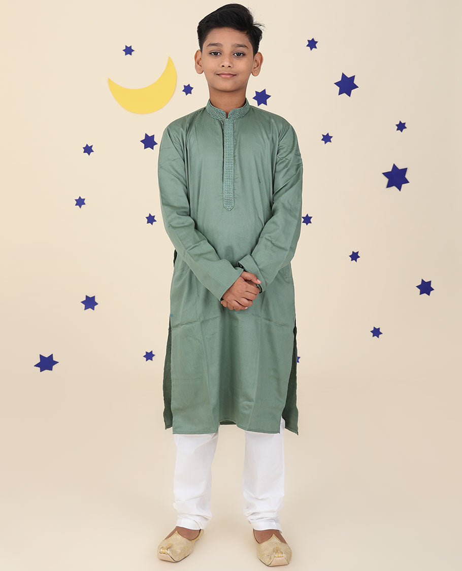 Green raw-silk kurta set features solid full-sleeve kurta & contrast pants