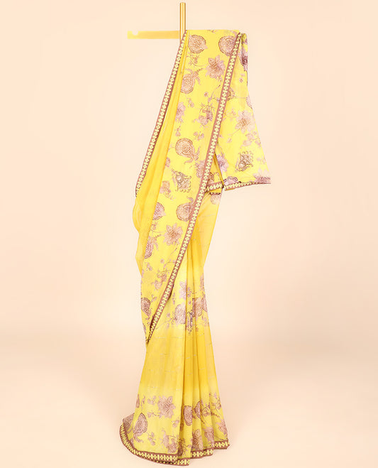 Yellow casual wear saree with floral vine designs on its body, contrast patchwork border 
