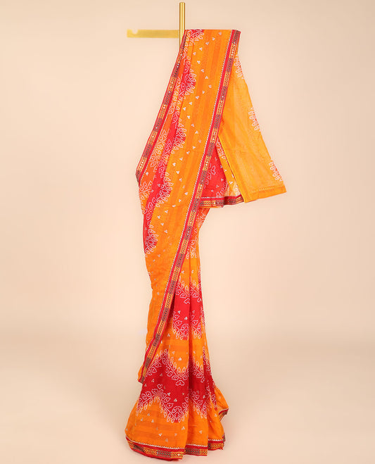 Orange bandhani polka dots printed casual wear saree features leaf creeper design, patchwork border 