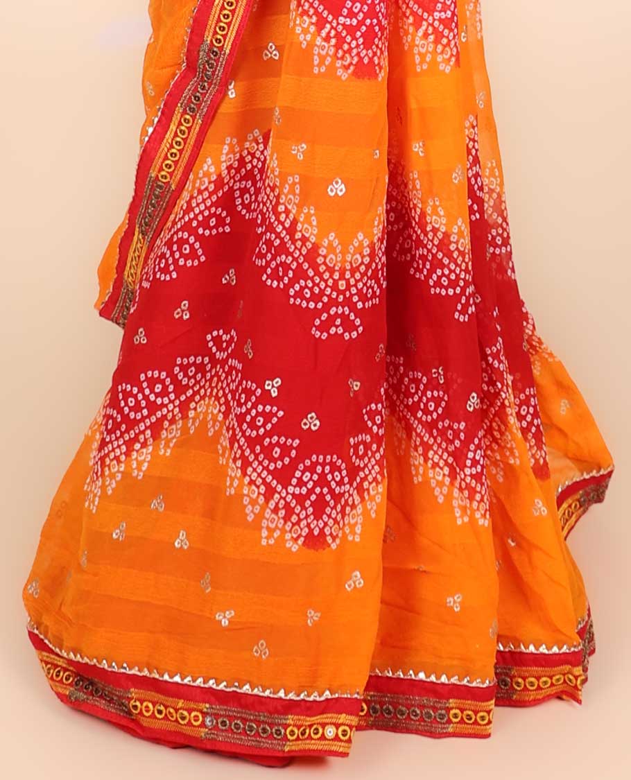 Orange bandhani polka dots printed casual wear saree features leaf creeper design, patchwork border 